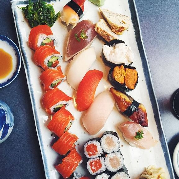 sushi platter of sashimi nigiri and sushi rolls